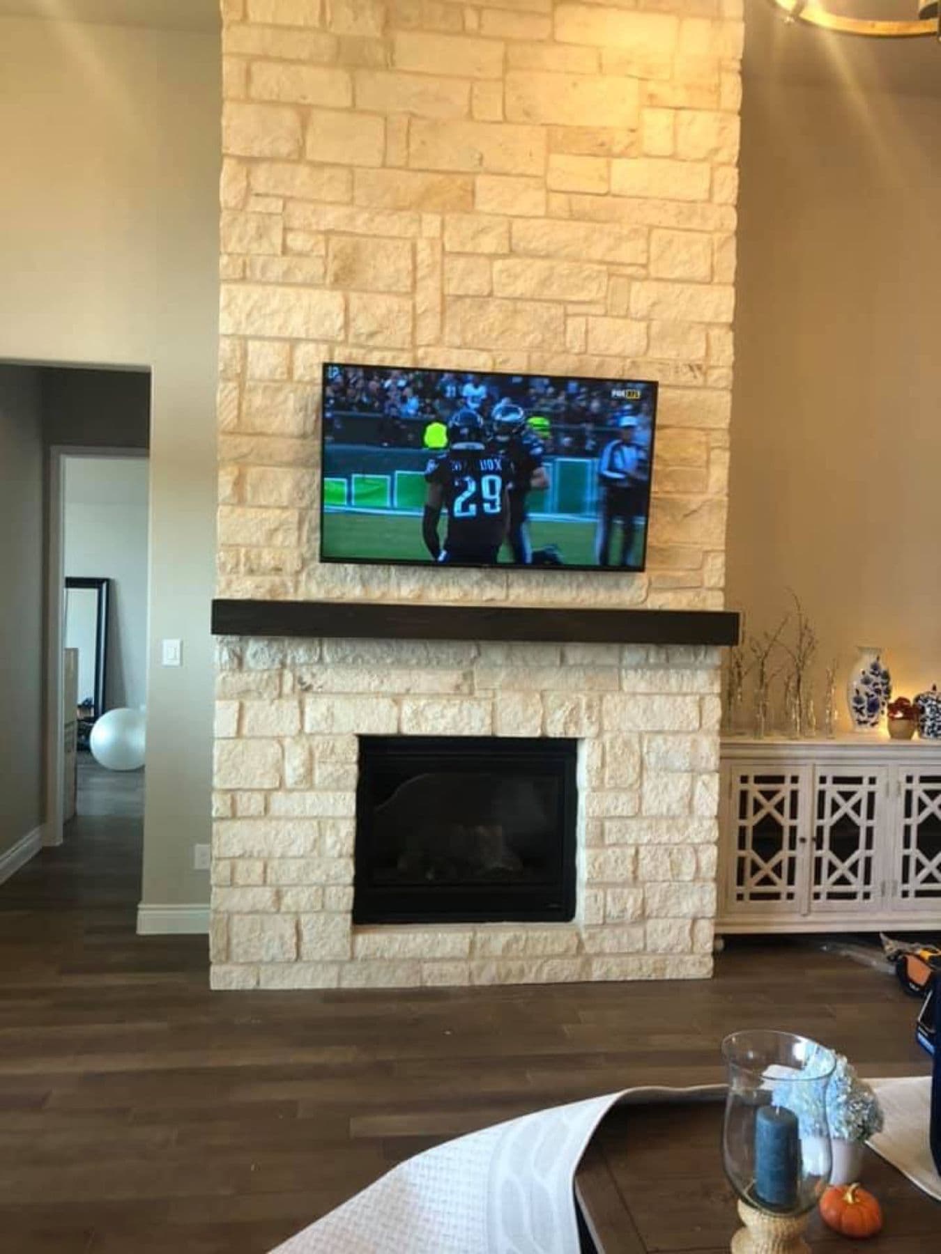 TV mounted on a stacked stone fireplace in a Dallas home