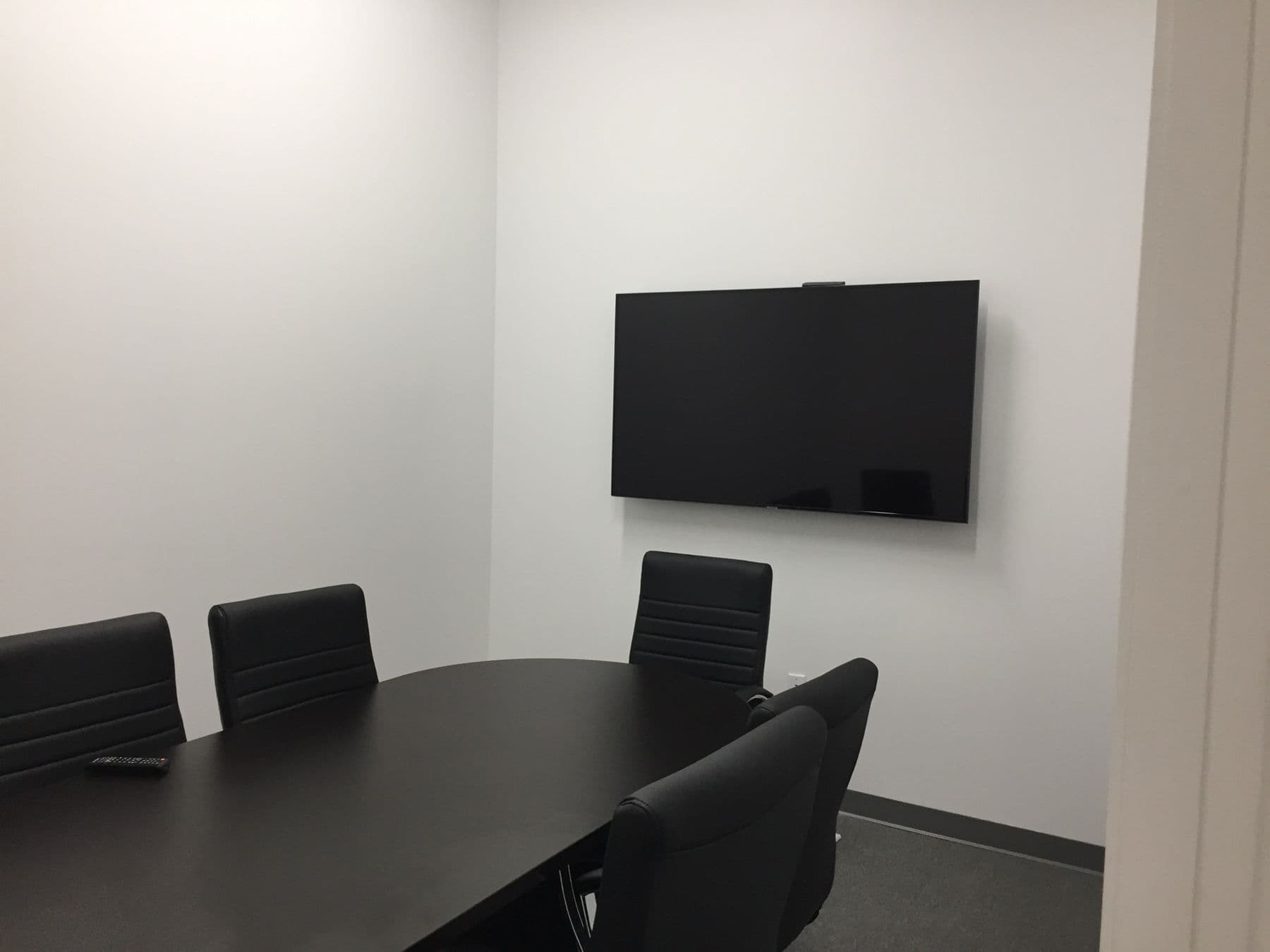 Office conference room large-format display with concealed cabling — Cognito commercial AV install, Plano TX