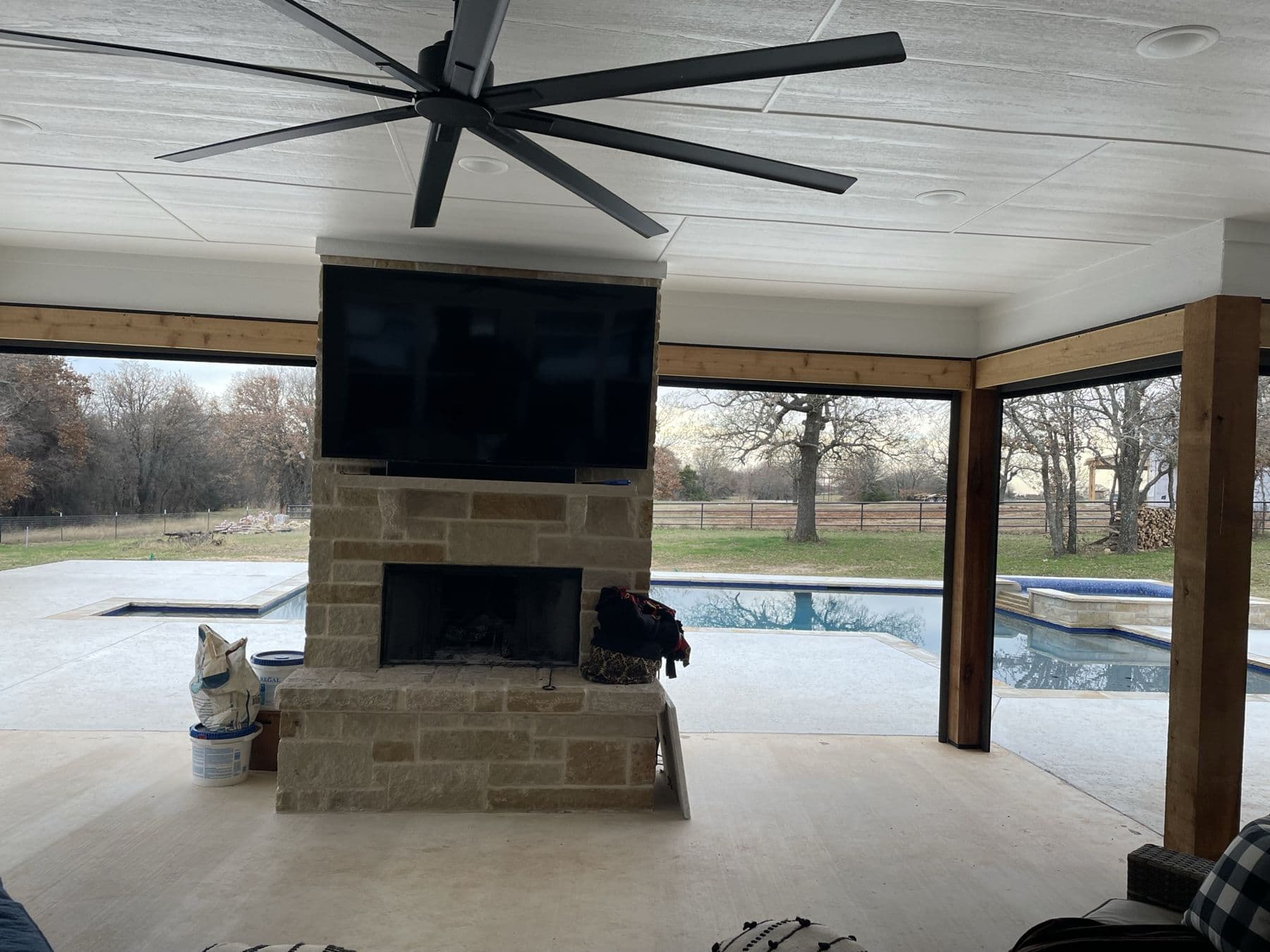 Cognito outdoor covered patio weather-rated TV mounting overlooking Southlake pool