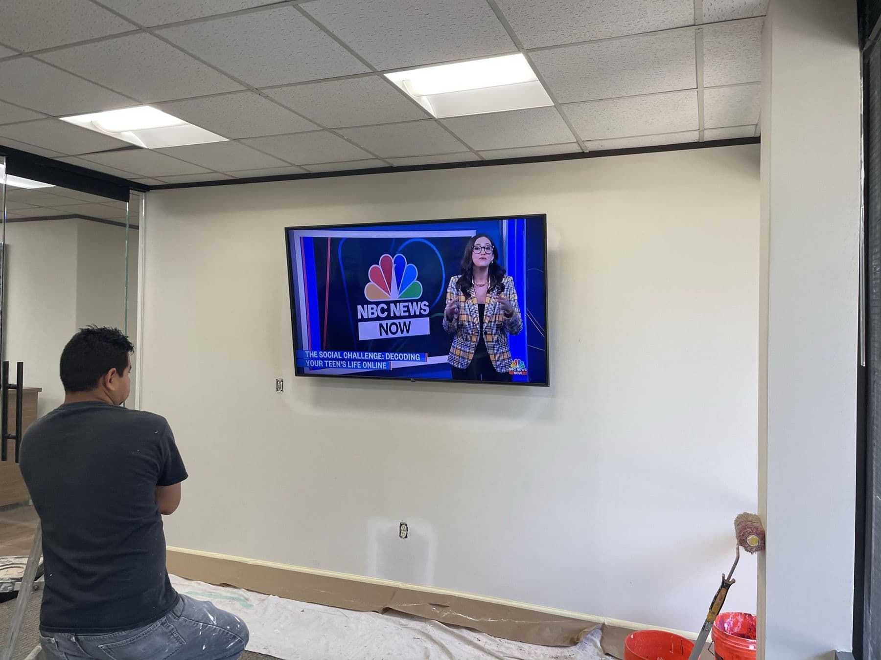 Cognito technician working a commercial TV install on-site at a Dallas business